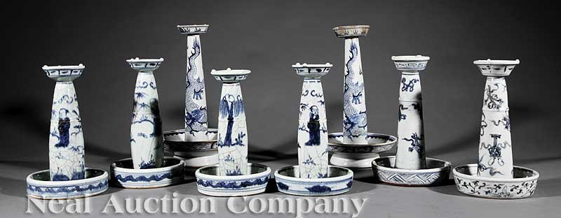 Eight Chinese Blue and White Candlestands: A Group of Eight Chinese Blue and White Porcelain Candlestands, comprised of four pairs variously decorated with figural, dragon and Buddhist emblem design, height 10 in. to 12 3/4 in