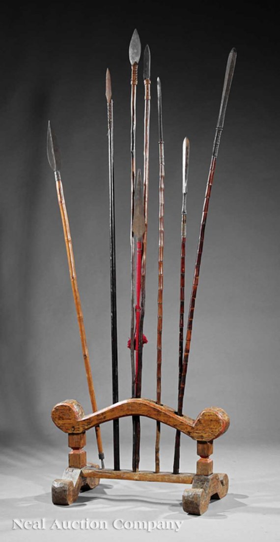 Southeast Asian Wood Spear Stand and Spears: A Southeast Asian Carved Wood Spear Stand and Eight Spears, polychrome painted stand pierced along the top with five spear holes, height 19 1/2 in., width 35 in., depth 18 in., fitted with 8 spears, w