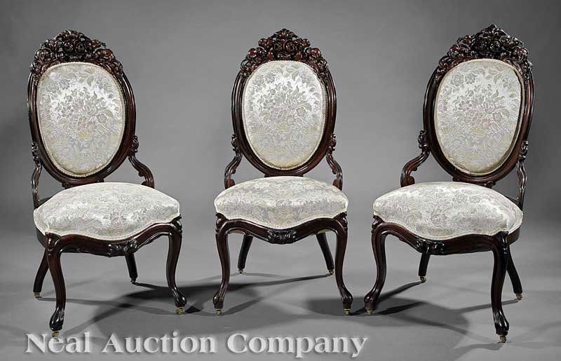 An American Rococo Rosewood Parlor Suite: An American Rococo Carved and Laminated Rosewood Parlor Suite, mid-19th c., New York, comprising two settees, three armchairs and three side chairs; shaped backs with floral and scrolled acanthus cres