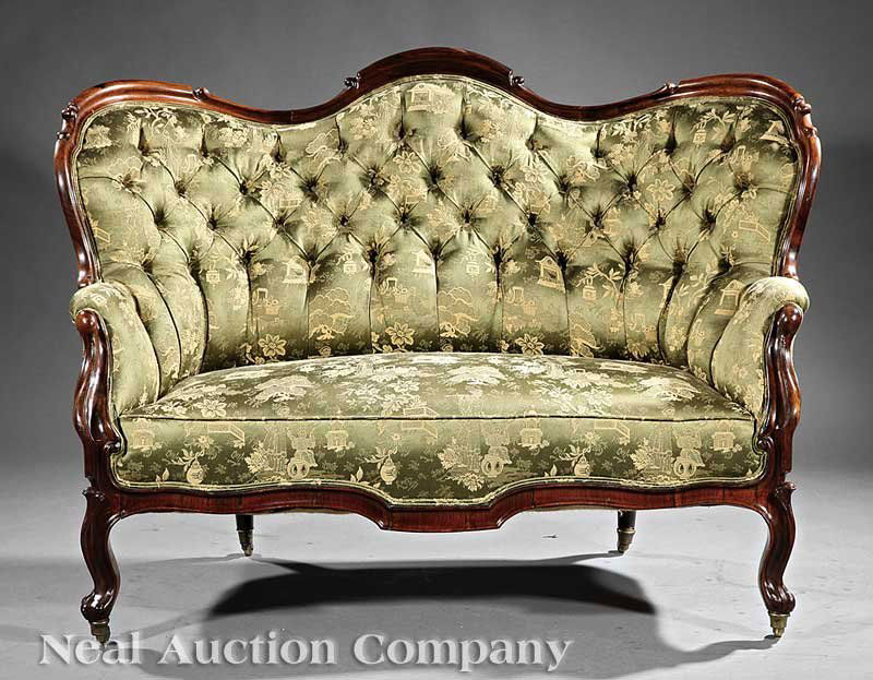 A Pair of Rococo Carved Rosewood Settees: A Pair of Small Rococo Carved Rosewood Settees, mid-19th c., shaped backs, low scroll arms, serpentine seat rails, cabriole legs, casters, height 41 in., width 51 1/2 in., depth 25 1/2 in