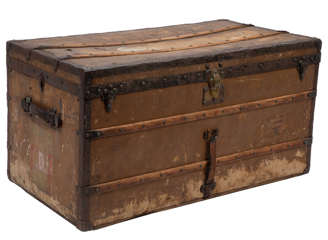 Vintage Louis Vuitton Steamer Trunk , h. 23 in., w. 44in., d. 22 1/2 in.: , early 20th c., Paris/London label, serial #113601, worn "LV" coated canvas, with remnants of labels and painted monograms, interior fitted with three removable trays, squat metal wheels, h. 23 in.,