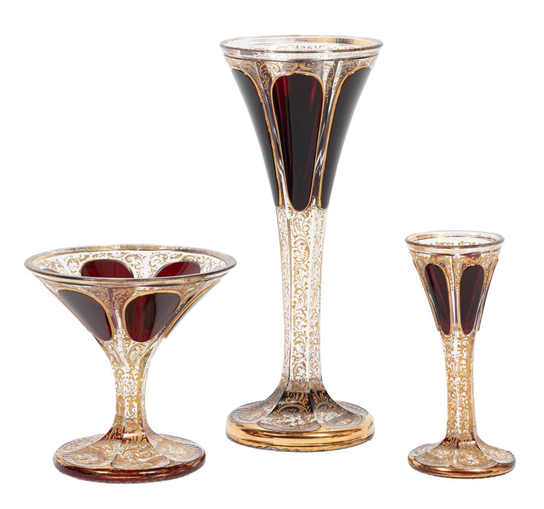 Twelve Pieces of Bohemian Gilt and Ruby Stemware: Twelve Pieces of Bohemian Gilt and Ruby Stemware , attributed to Moser, engraved gilt design, with ruby reserves, incl. 4 wine, h. 9 3/8 in., 4 champagne coupes, and 4 cordials.