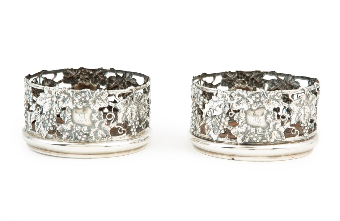 Pair of Gorham Sterling Silver Vintage Motif Wine Coasters: Pair of Gorham Sterling Silver Vintage Motif Wine Coasters, no. A4839, reticulated grape, grape leaf and vine motif gallery, reserve monogrammed "JA", turned wood bottom, h. 2 ½ in., di