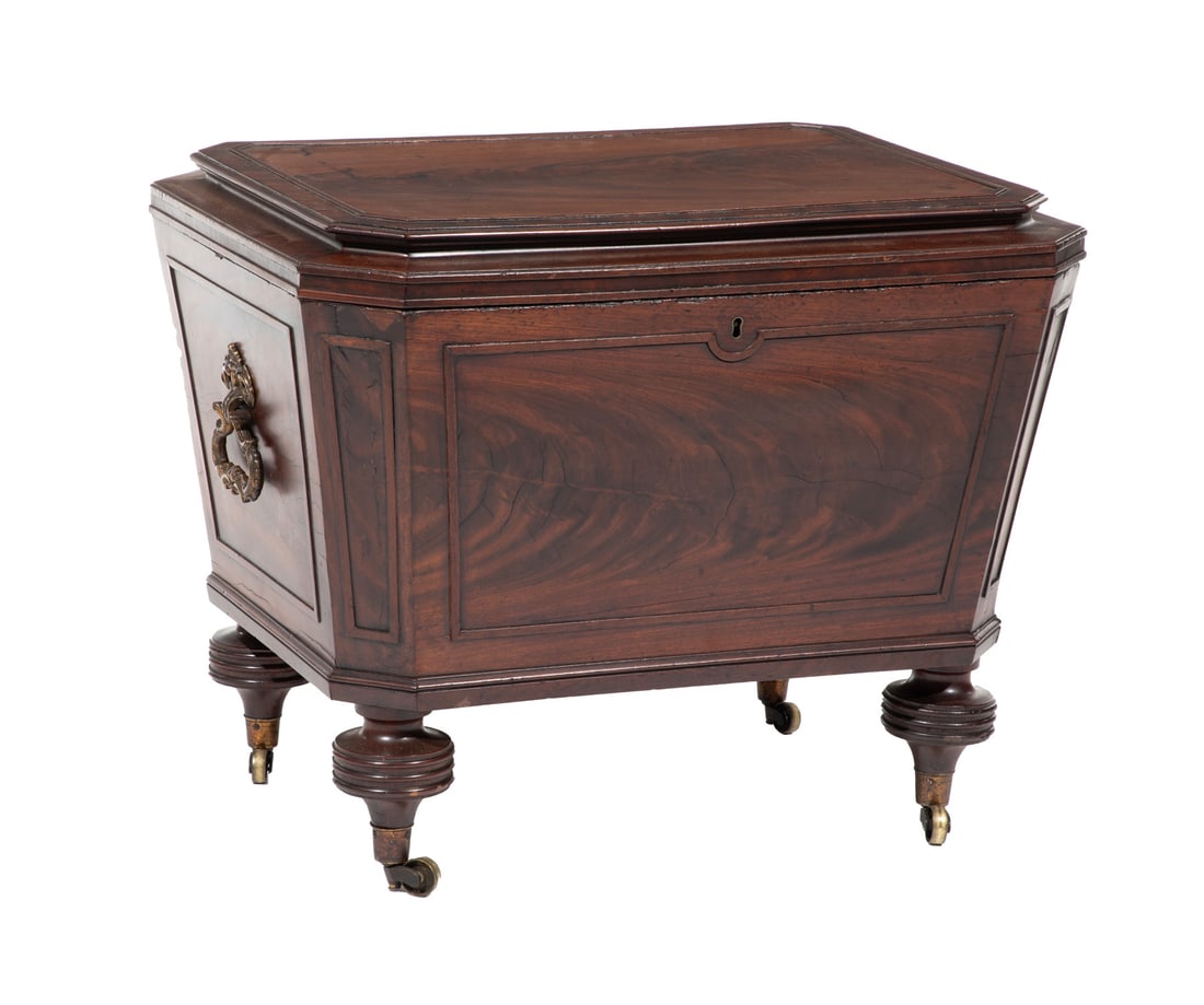 Regency Carved Mahogany Cellarette h. 22 in., w. 27 in., d. 20 1/4 in.: Regency Carved Mahogany Cellarette, 19th c., molded hinged top, fitted liner, molded sides, canted corners, brass handles, turned feet, castors, h. 22 in., w. 27 in., d. 20 1/4 in.h. 22 in., w. 27 in.