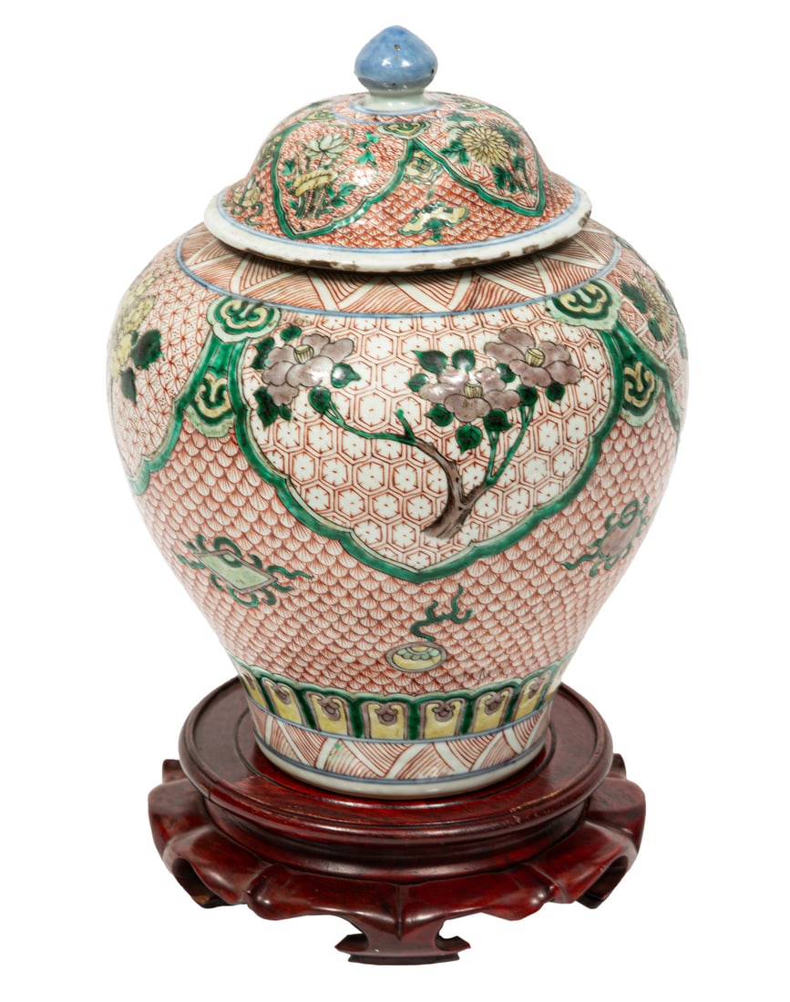 Pair of Chinese Wucai Porcelain Covered Jars: Pair of Chinese Wucai Porcelain Covered Jars, Qing Dynasty (1644-1911), painted with floral pendants and scattered Buddhist emblems on various red diaper grounds, interior with "Michael Davis / S