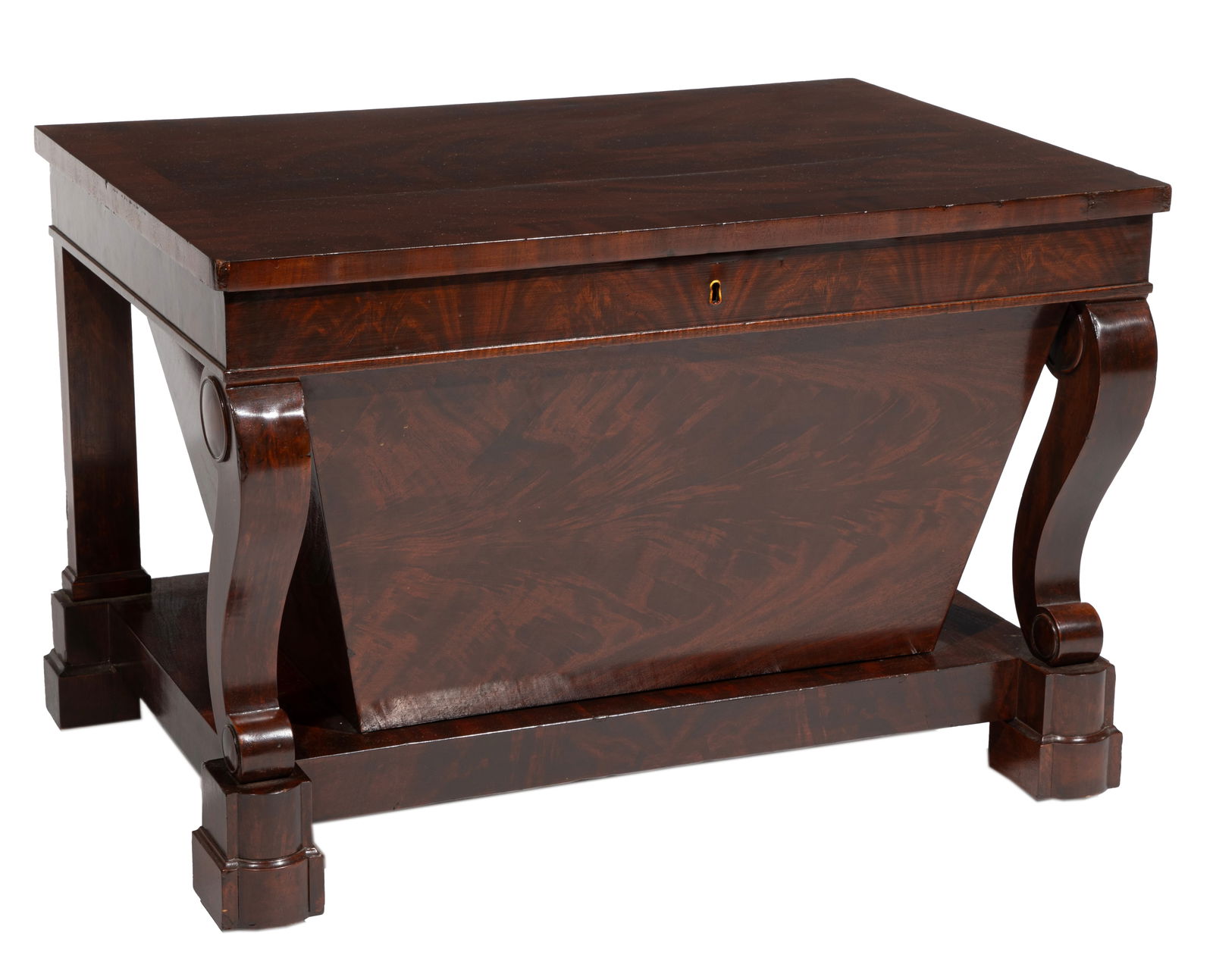 Rare American Classical Flame Mahogany Cellarette 19 x 28 x 19 in. (48.3 x 71.1 x 48.3 cm.): Rare American Classical Flame Mahogany Cellarette, mid 19th c., attributed to Duncan Phyfe & Son, New York, banded lift top, fitted bottle interior, sarcophagus-form case, scrolled front supports, pli