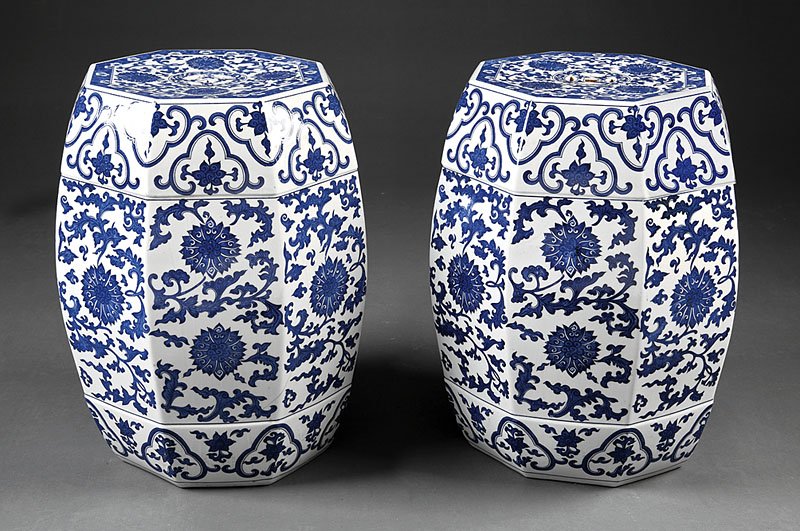 Chinese Blue & White Porcelain Octagonal Stools: A Fine Pair of Chinese Blue and White Porcelain Octagonal Barrel Stools, the tops with pierced cash symbols, the bodies decorated with lotus blossoms and scrolling foliage, height 19 in Provenance: Tr