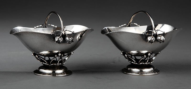 George Jensen Sterling Silver Bonbon Baskets: A Pair of George Jensen Sterling Silver Bonbon Baskets, design no. 235B, introduced c. 1917, designer Georg Jensen; height 3 3/4 in., length 5 in., depth 3 3/4 in., weight 12.85 troy ozs. Reference: T