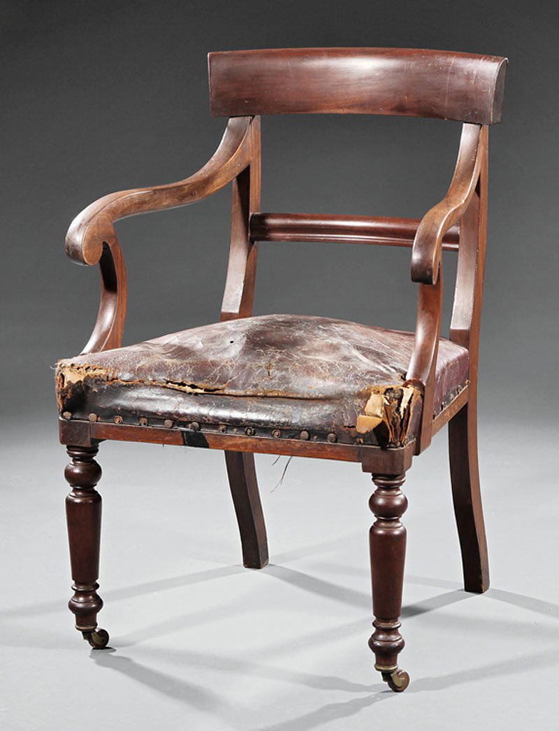 English Carved Mahogany Armchair: An English Carved Mahogany Armchair, seat rail marked with Monarch's stamp, crown over "GR/V", tablet crest rail, scrolled arms, turned legs, casters