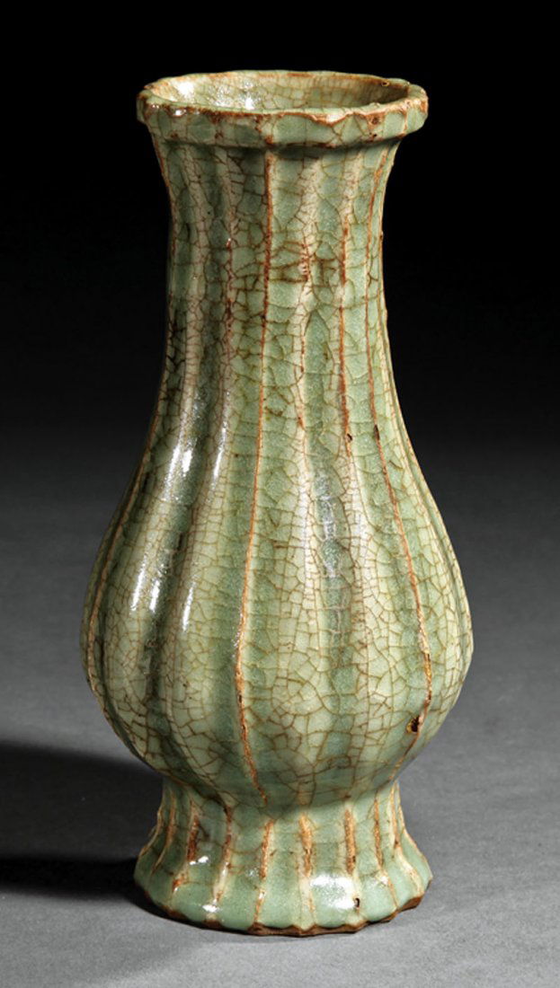 Chinese Celadon Vase: A Chinese Celadon Vase, probably Ming Dynasty (1368-1644) or earlier, ribbed bottle form body with splayed foot and flared mouth, height 7 1/2 in