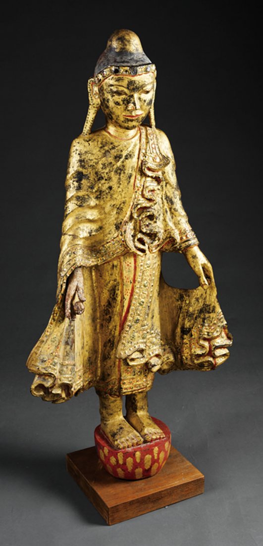 Thai Mirror "Gem" Inset Giltwood of a Buddha: A Thai Mirror "Gem" Inset Giltwood Figure of a Buddha, 20th c., standing figure carved holding his robes open, on a hemispherical base, height 40 1/2 in., wood plinth, overall height 42 1/2 in