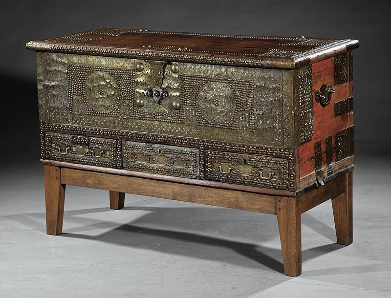 Indo-African Brass-Mounted Hardwood Chest: An Antique Indo-African Brass-Mounted Hardwood "Treasure" Chest, Zanzibar, rectangular trunk form over three frieze drawers, hinged lid opening to fitted interior, exterior embellished with pierced br
