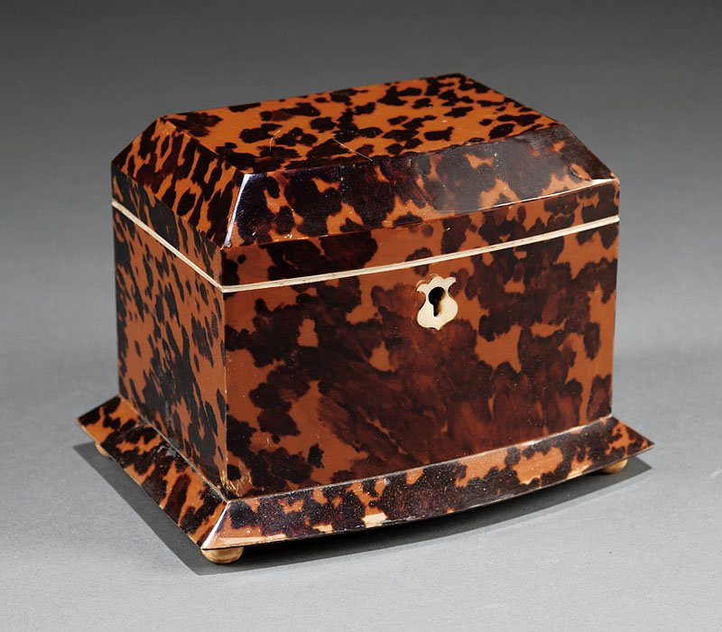 Small English Tortoiseshell Tea Caddy: A Small English Tortoiseshell Tea Caddy, 19th c., interior with divided lidded compartments, shield form escutcheon, with key, on bun bone feet, height 4 1/4 in., width 5 7/8 in., depth 4 in