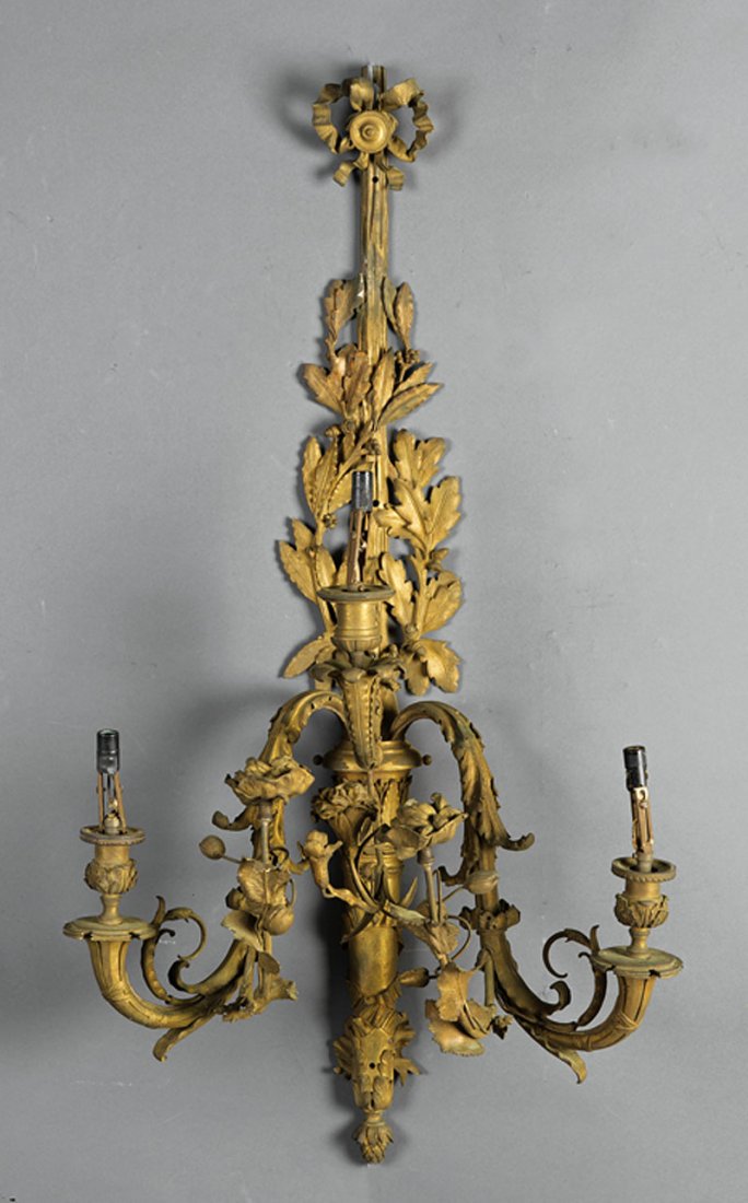Louis XVI-Style Gilt Bronze Three-Light Sconces: A Pair of Louis XVI-Style Gilt Bronze Three-Light Sconces, 19th c., ribbon and quiver form backplate intertwined with oak and laurel branches, issuing scrolled supports and realistically modeled carna