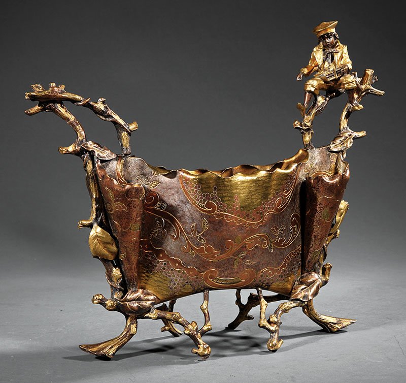Continental Mixed Metals Jardiniere: A Continental Mixed Metals Jardiniere, late 19th c., ovoid form with applied foliate decoration, surmounted by figure of a school boy, overall incised floral and scroll decoration, height 15 1/2 in., 