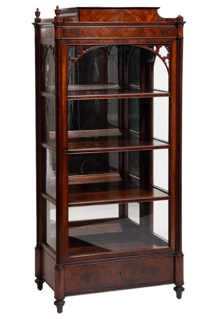 American/English Gothic Revival Carved Mahogany Vitrine: American/English Gothic Revival Carved Mahogany Vitrine , 19th c., sarcophagus top, glazed door with gothic tracery molding, mirrored back, shelved interior, plinth drawer, turned feet 63 x 29 1/2 x 1