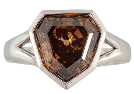 Modern Platinum and Brown Diamond Ring: Modern Platinum and Brown Diamond Ringcenter bezel set shield step cut fancy intense brown diamond, wt. approx. 5.07 cts.; size 7; AIGL report.Please Note: Payment for all jewelry and all couture item