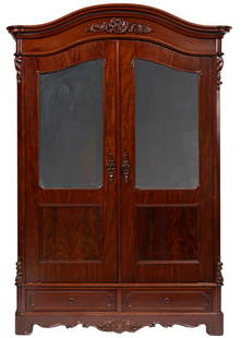 American Rococo Carved Mahogany Double Door Armoire: American Rococo Carved Mahogany Double Door Armoire, 19th c., New Orleans, arched molded cornice, molded mirrored doors, two plinth drawers, paneled sides, scrolled apron99 x 67 1/2 x 24 1/2 in. (251.