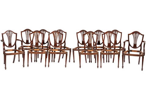 Set of Twelve Hepplewhite-Style Carved Mahogany Dining Chairs: Set of Twelve Hepplewhite-Style Carved Mahogany Dining Chairs, 19th & later c., two arms and ten sides, molded shield back, pierced caved splat, upholstered seats, fluted tapered legsARM 38 x 21 1/2 x