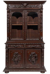 Renaissance Revival Carved Oak Bookcase: Renaissance Revival Carved Oak Bookcase, 19th c., molded cornice, frieze centered head, glazed doors, two drawers above molded cabinet doors, plinth base, turned feet95 x 56 x 23 1/2 in. (241.3 x 142.