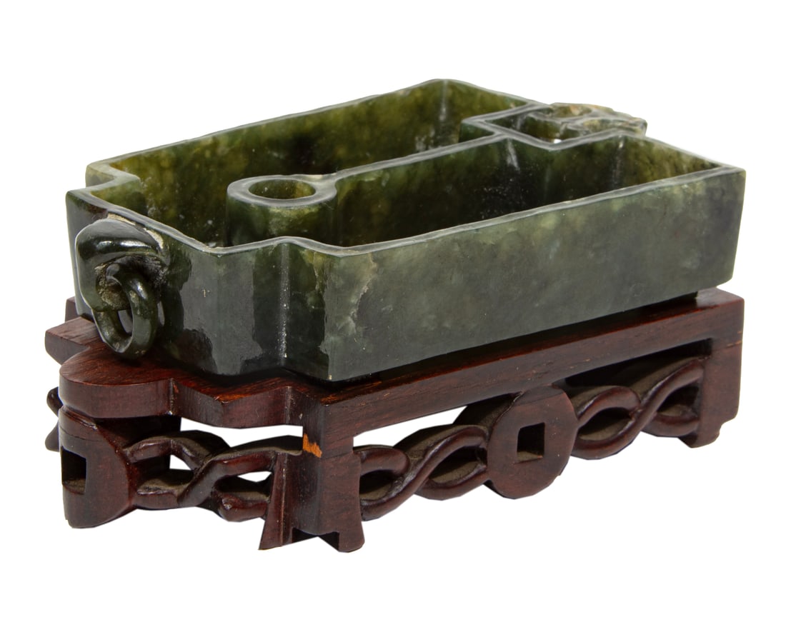Chinese Spinach Green Jade Inkwell: Chinese Spinach Green Jade Inkwell, archaistic-form with loose ring handles, bracket feet, h. 7/8 in., w. 4 1/4 in., d. 2 3/4 in., wood stand, overall h. 1 3/4 in., w. 4 1/2 in., d. 2 5/8 in.