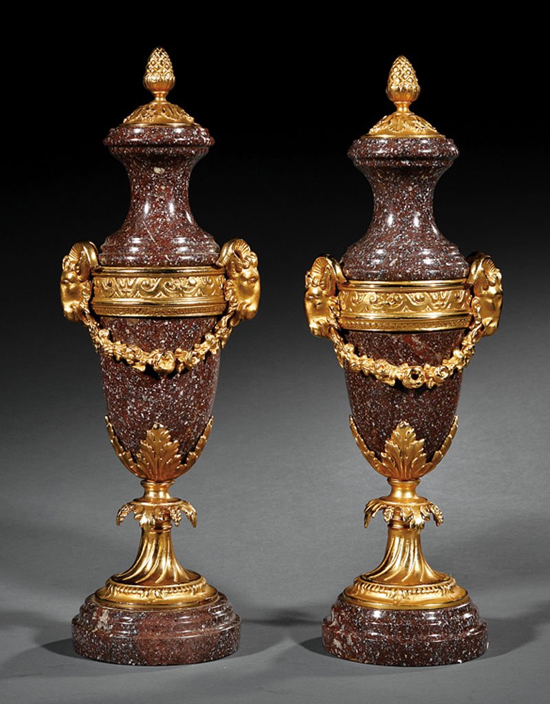 A Pair of Louis XVI-Style Marble Cassolettes: A Pair of Louis XVI-Style Gilt Bronze-Mounted "Porphyry" Marble Cassolettes, pineapple finials, rams' heads handles with floral garlands, height 17 1/4 in