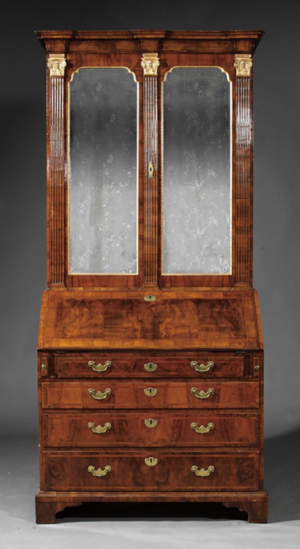 A Georgian Inlaid Walnut Secretary Bookcase: A Fine Georgian Inlaid Walnut and Parcel Gilt Secretary Bookcase, 18th c., upper case with blocked cornice, fluted stiles flanking shaped mirrored doors; lower case with slant front desk, finely fitte