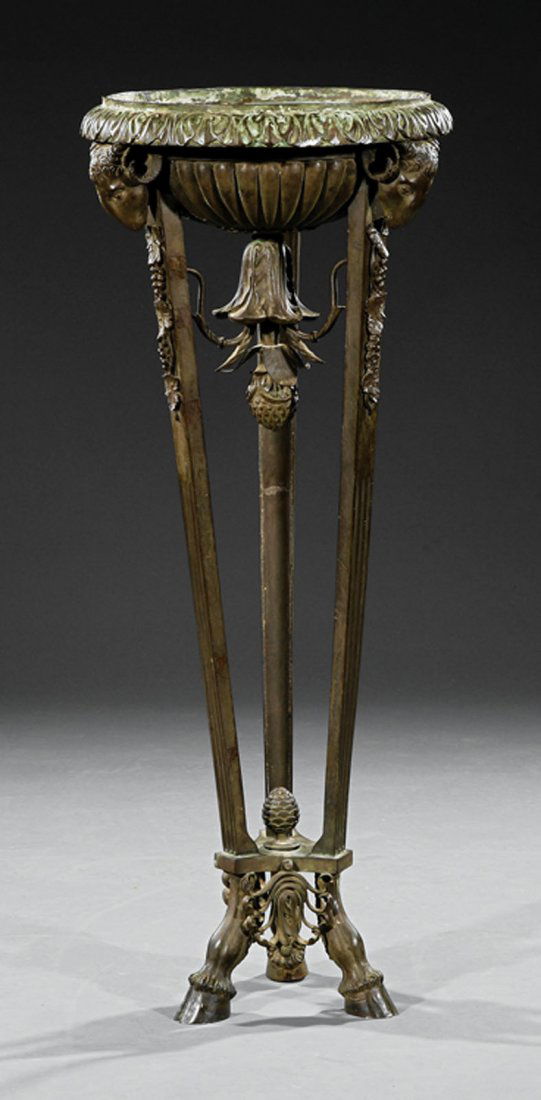 A Neoclassical Athenienne style of Robert Adam: A Neoclassical Patinated Bronze Athenienne, 19th c., in the style of Robert Adam, lobed bowl with foliate rim, pineapple pendant, ram's head mounts on fluted supports, hoof feet, height 39 3/8 in., di