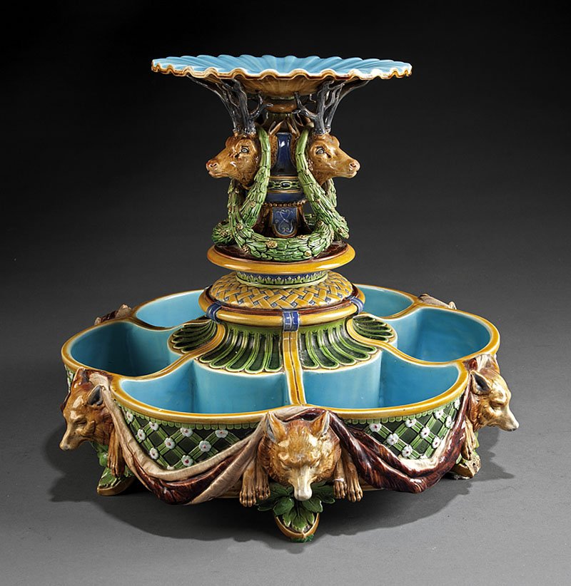 A Minton Majolica Figural Ice Stand Centerpiece: A Minton Majolica Figural Ice Stand Centerpiece, fully marked, date mark for 1865, scalloped dish over stag heads draped with pine needles and cones, diaper pattern motifs, the frieze modeled with wol