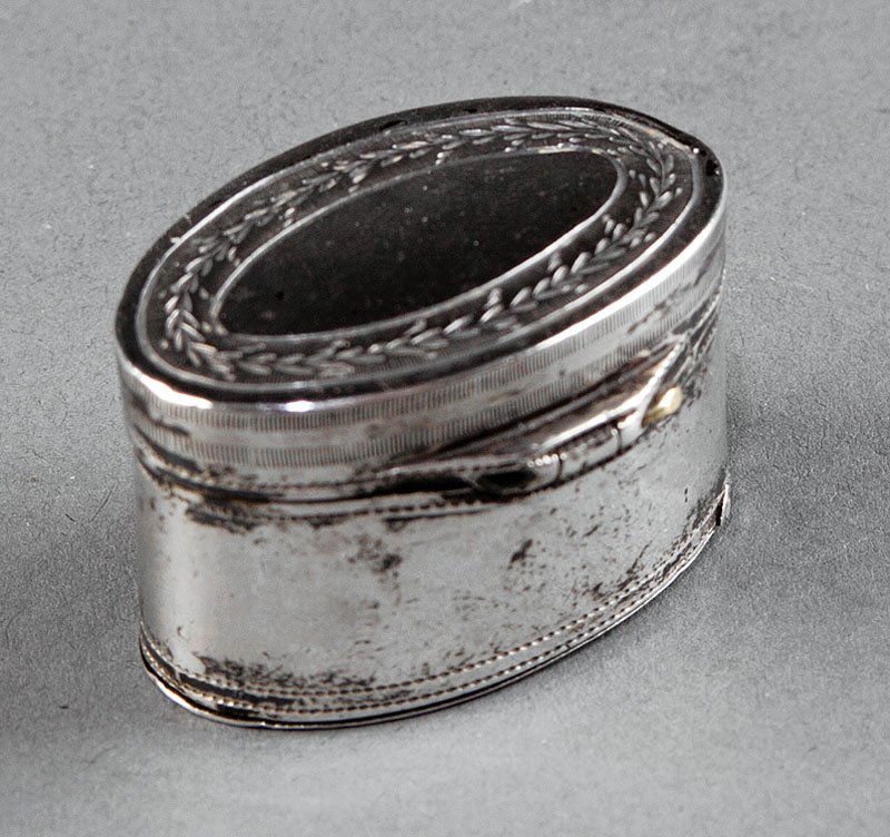 A George III Sterling Silver Nutmeg Grater: A George III Sterling Silver Nutmeg Grater, Birmingham, 1799, maker SR untraced, oval with hinged cover and "trap door", bright cut decoration, length 1 3/8 in., weight.65 troy ozs