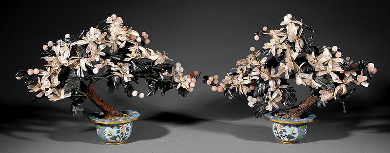 A Pair of Chinese Hardstone Trees: A Pair of Chinese Hardstone Trees Set in Cloisonne Enamel Cachepots, 20th c., naturalistic trunks with fabric wrapped branches issuing hardstone and rose quartz leaves and flowers, approx. height 17 1