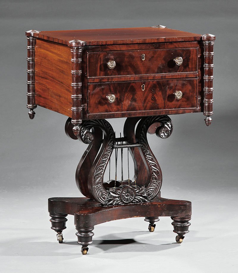 An American Classical Carved Mahogany Work Table: An American Classical Carved Mahogany Work Table, early 19th c., case with turreted corners and pendants, two drawers, carved lyre support, incurvate plinth, turned disc feet, casters, height 28 3/4 i