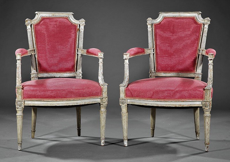 A Pair of Louis XVI-Style Creme Peinte Fauteuils: A Pair of Antique Louis XVI-Style Creme Peinte Fauteuils, each with shaped crest rail, padded arms, seat rail with rosette blocks, turned tapered legs