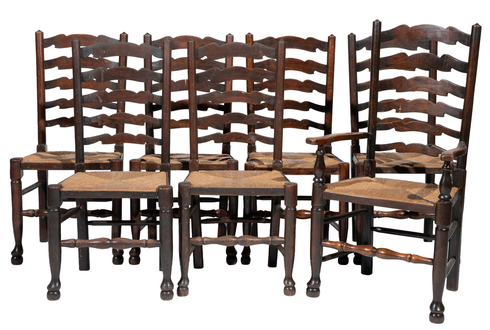 Set of Seven Yorkshire Carved Oak Dining Chairs: Set of Seven Yorkshire Carved Oak Dining Chairs 20th c., slat back, turned legs and stretchers, rush seats, one armchair and six side chairs