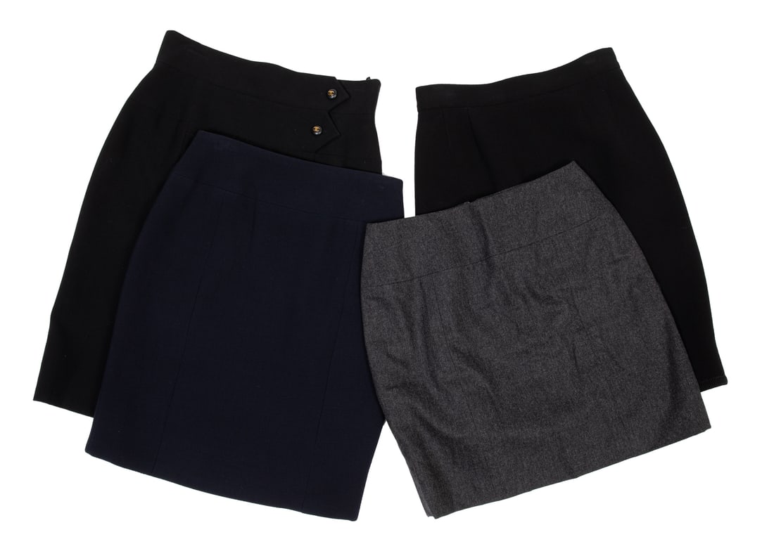 Four Vintage Chanel Wool Skirts: Four Vintage Chanel Wool Skirts labeled, made in France, incl. navy skirt, Fall/Winter 1997, size 42; black skirt with logo buttons, Cruise 1995, size 42; black wool skirt, size 42; and grey wool skir