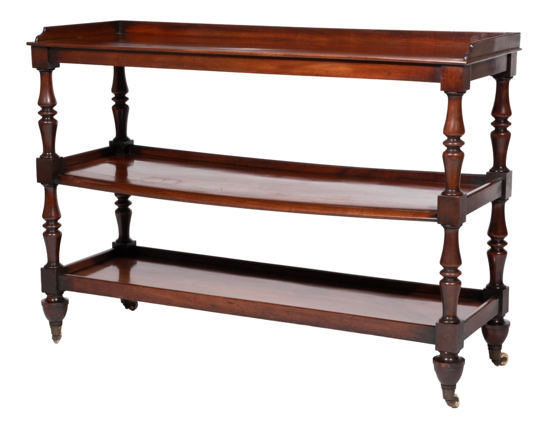 William IV Carved Mahogany Three Tier Trolley: William IV Carved Mahogany Three Tier Trolley19th c., galleried tiers, turned supports, tapered turned legs, casters38 1/4 x 54 x 19 in. (97.2 x 137.2 x 48.3 cm.)