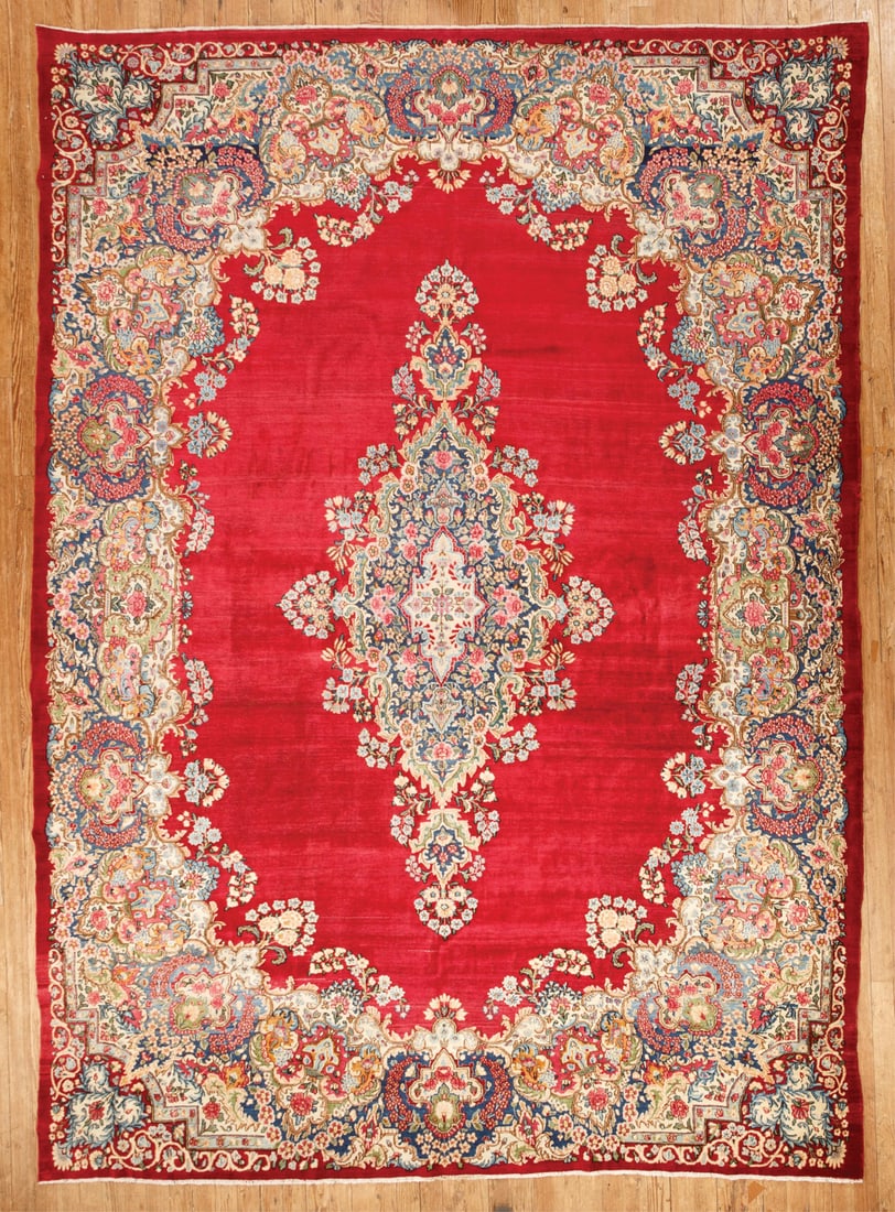 Persian Kerman Carpet: Persian Kerman Carpet, red ground, central medallion, floral border,10 ft. x 13 ft. 10 in