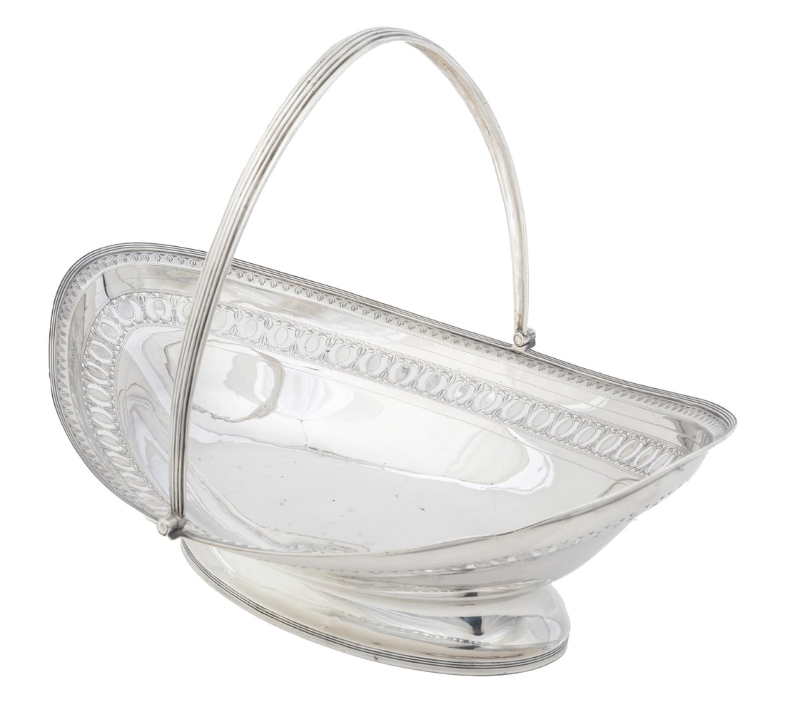 George III Sterling Silver Cake Basket: George III Sterling Silver Cake Basket,London, 1804, marks rubbed; navette form, reeded handle, rim and foot rim, reticulated border.Provenance: Collection of Louise Hymes ManheimHeight (to top of han