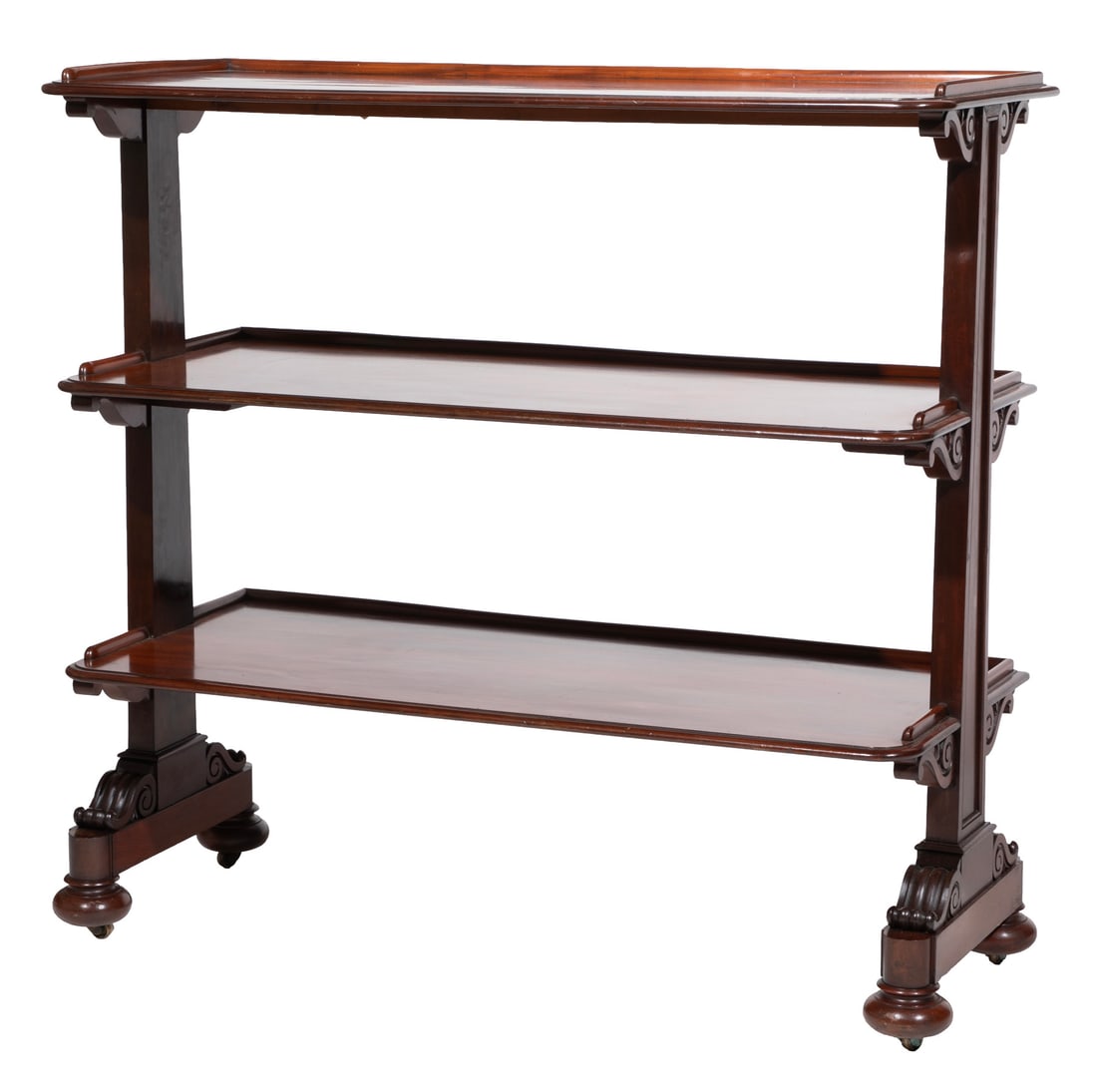 Regency Carved Mahogany Three Tier Trolley: Regency Carved Mahogany Three Tier Trolleyearly 19th c., after Thomas King design, galleried shelves, scrolled supports, trestle base, turned feet, casters47 x 48 x 20 1/2 in. (119.4 x 121.9 x 52.1 cm