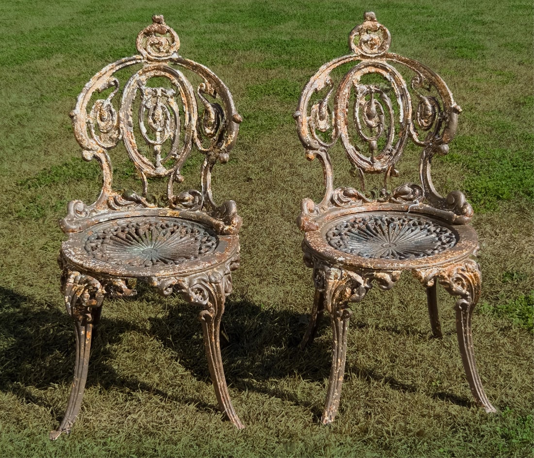 Pair of Diminutive Antique American Cast-Iron Garden Chairs, scroll back, slightly concave seat, h.: Pair of Diminutive Antique American Cast-Iron Garden Chairs scroll back, slightly concave seat, h. 30 in., w. 14 in., d. 17 in. Illustrated: Israel, Barbara. Antique Garden Furniture, Two Centuries of