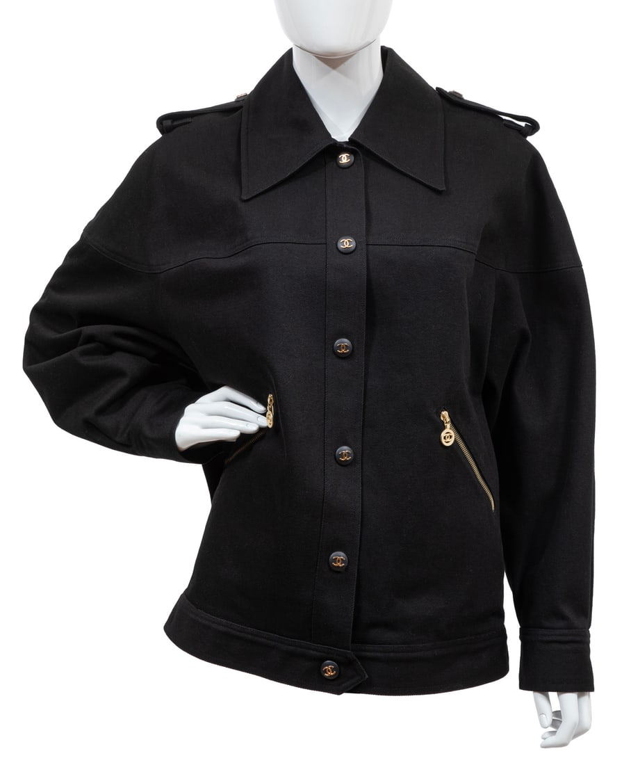 Vintage Chanel Black Denim Jacket: Vintage Chanel Black Denim Jacketlabeled "Chanel", gold-tone logo buttons, lacking size label, chest w. 23 in., l. 26 1/2 in., sleeve l. 17 in.
