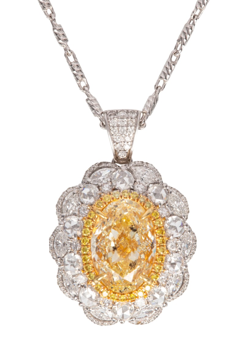 18 kt. White Gold, Yellow Diamond and Diamond Convertible Pendant Ring with Chain: 18 kt. White Gold, Yellow Diamond and Diamond Convertible Pendant Ring with Chaincenter oval modified brilliant cut Fancy Light Yellow Diamond, wt. approx. 5.29 cts.; inner bezel with 30 round brillia