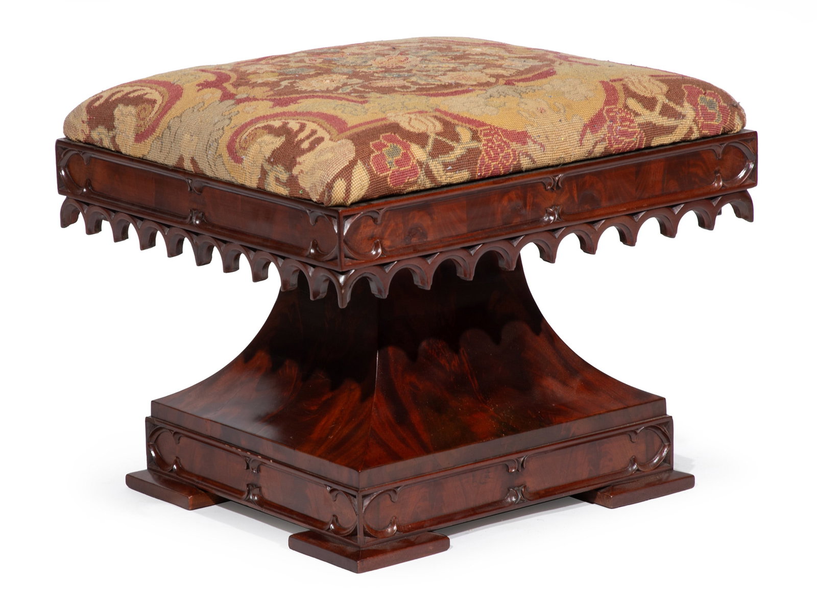 American Gothic Carved Mahogany and Needlepoint Stool: American Gothic Carved Mahogany and Needlepoint Stool mid-19th c., attributed to Crawford Riddell, Philadelphia, molded frieze with tracery and arcaded carving, waisted pillar support on conforming mo
