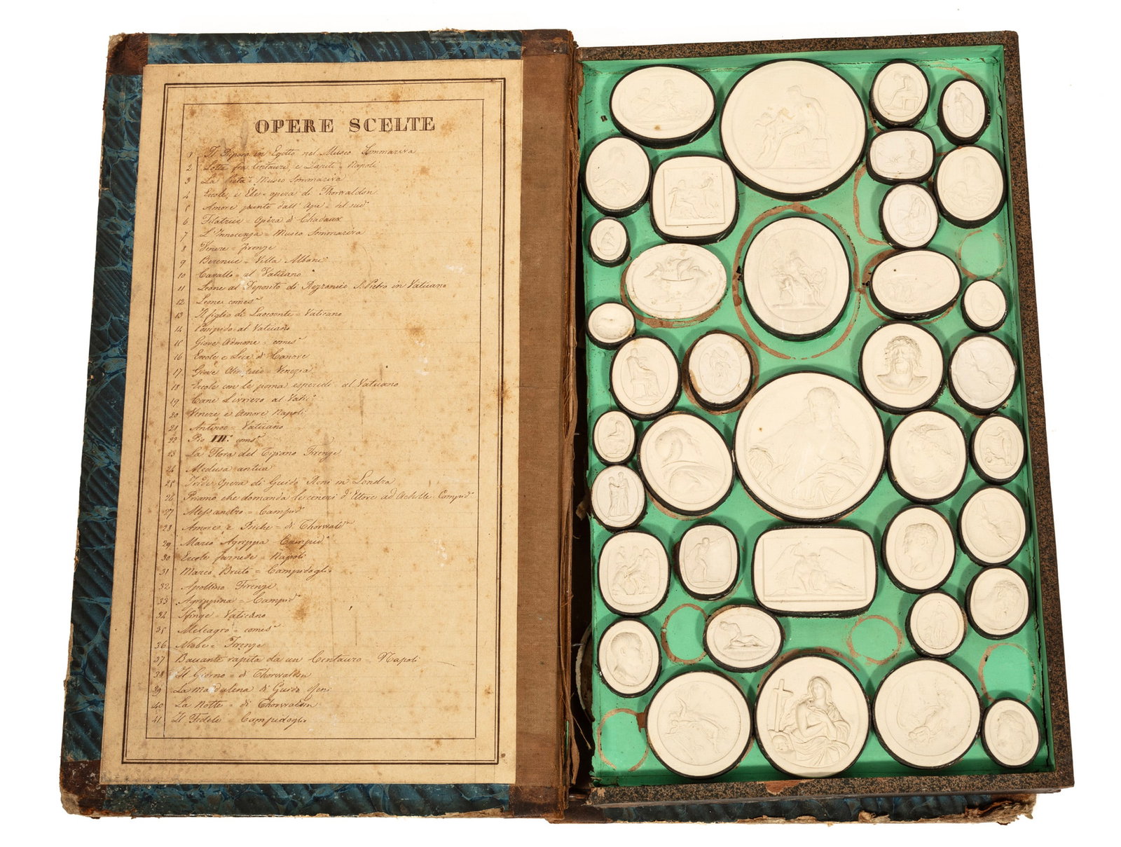 Collection of Grand Tour Plaster Intaglios: Collection of Grand Tour Plaster Intaglios 19th c., 55 intaglios, housed in a book-form box, with an Italian handwritten index on the interior lid,13 3/4 in. x 8 1/2 in.