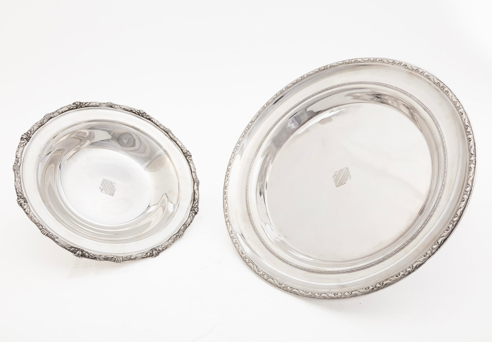 Two American Sterling Silver Circular Dishes: Two American Sterling Silver Circular Dishes, including S. Kirk & Son Inc. no. 3621, diameter 11 in.; and International no. W481, diameter 14 in.; each with floral and foliate molded border, monogramm