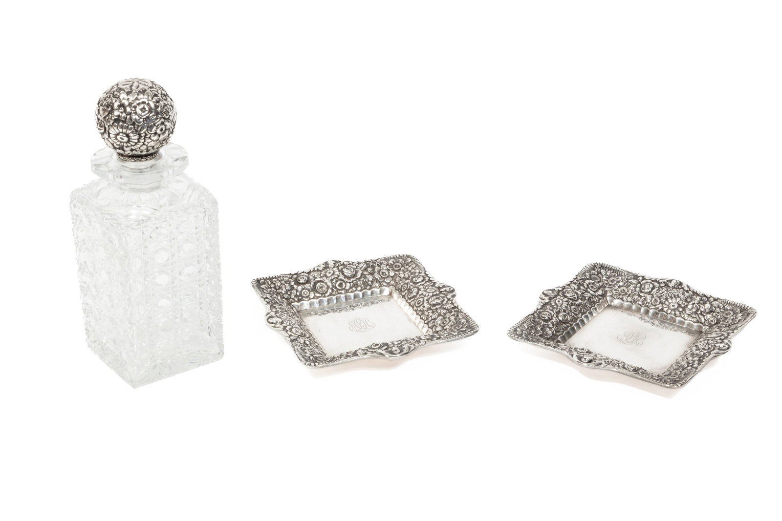 Tiffany Sterling Silver Repousse and Cut Glass Decanter: Tiffany Sterling Silver Repousse and Cut Glass Decanter, 1869-1891, pattern introduced 1885, square hobnail motif decanter, flower and fern motif stopper, two square flower and fern motif decanter sta