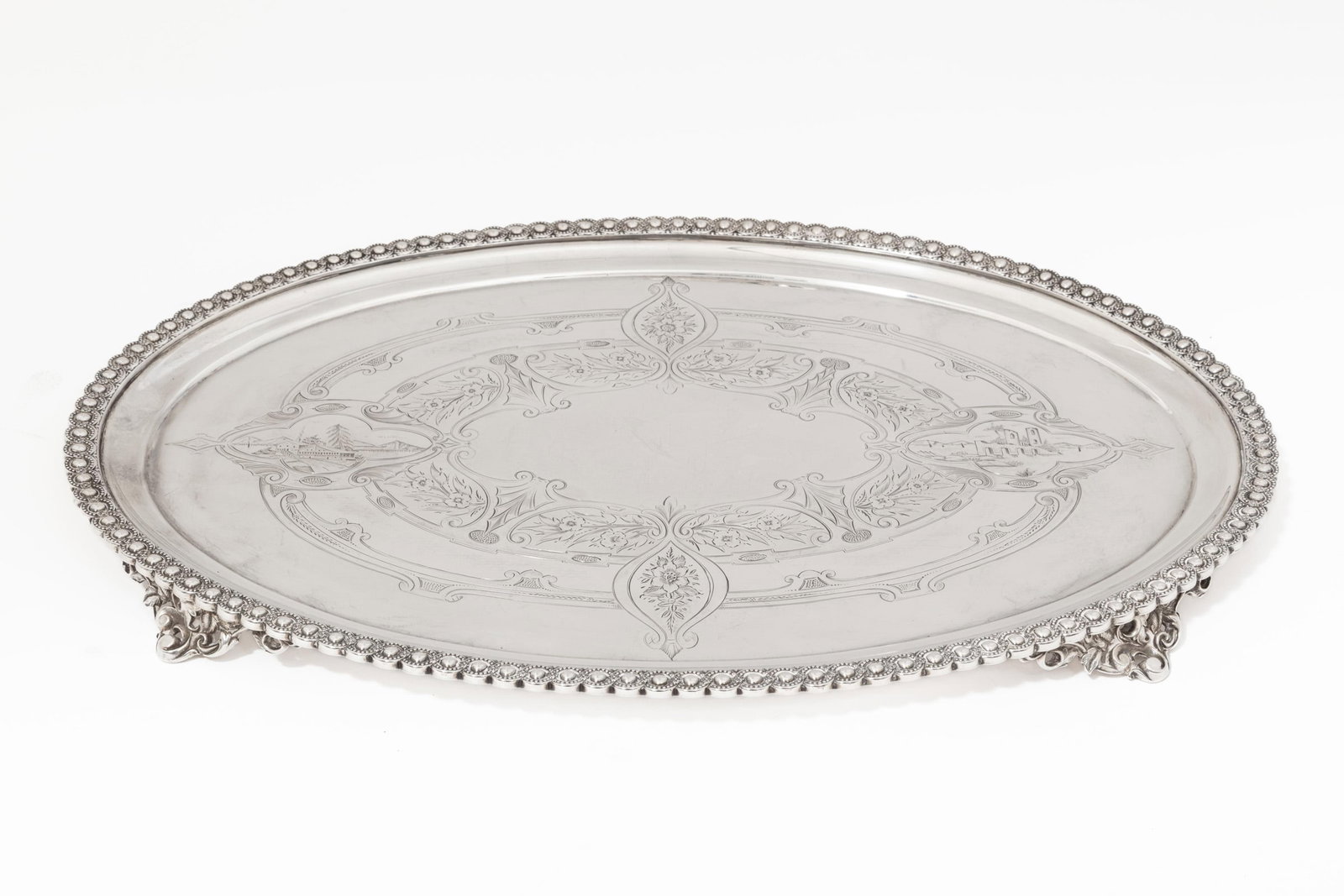 New Orleans Coin Silver Oval Tray: New Orleans Coin Silver Oval Tray, E. A. Tyler, wc. 1838-1879, incised mark under rim "E.A.TYLER N.O.", guilloche bordered rim, chased flat well with vacant reserve, reticulated scroll feet. Ref. Cres