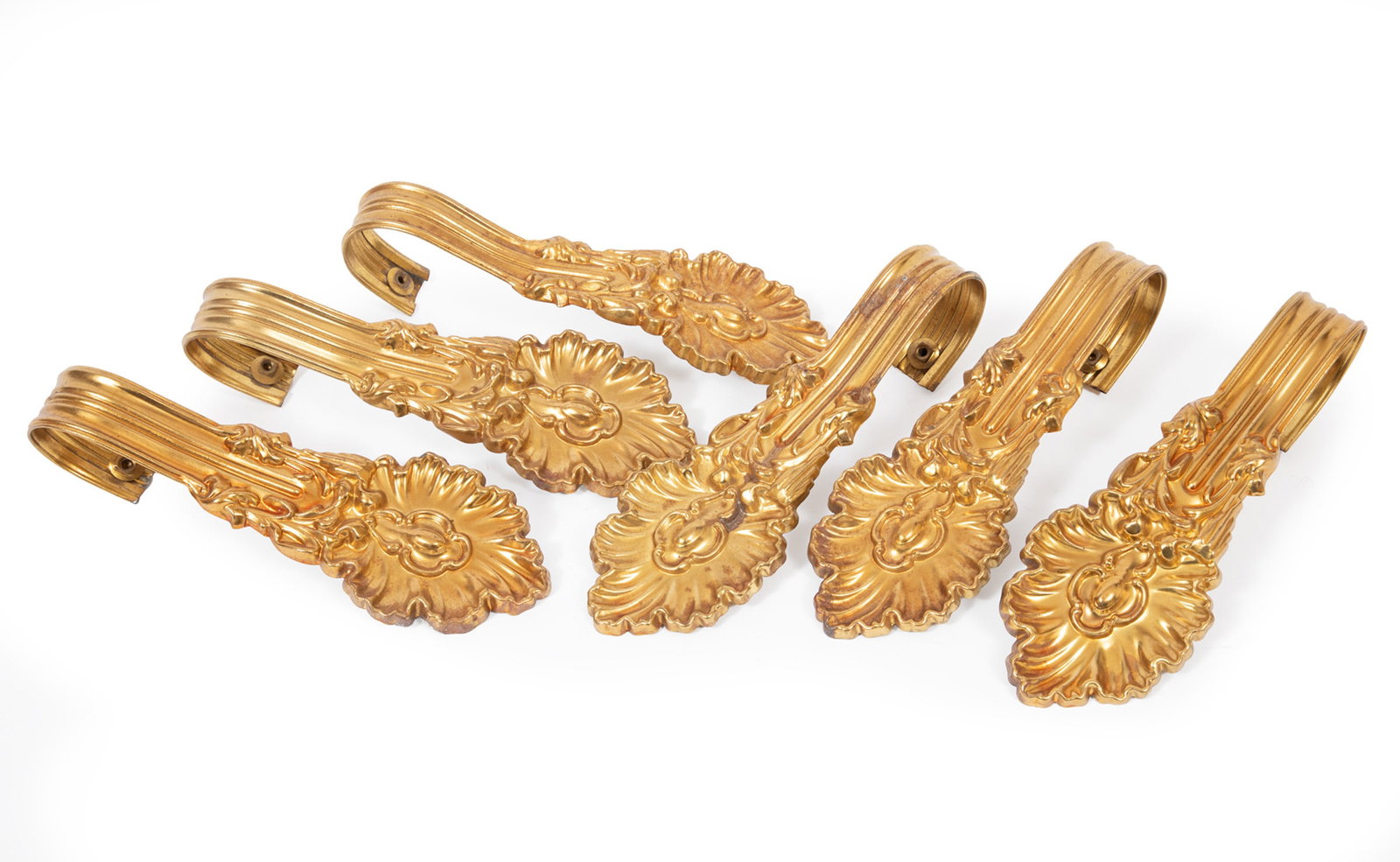 Six Antique Gilt Brass Tiebacks: Six Antique Gilt Brass Tiebacks , mid-19th c., 3 1/4 x 9 x 2 1/2 in. (8.3 x 22.9 x 6.4 cm.)