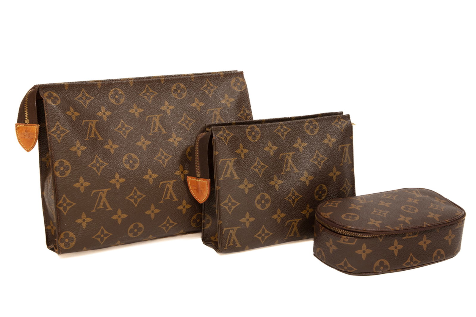 Group of Louis Vuitton Travel Accessories in Brown Monogram Coated Canvas: Group of Louis Vuitton Travel Accessories in Brown Monogram Coated Canvas incl. 2 toiletry pouches, h. 7 1/2 in., w. 10 in., d. 2 in, and h. 5 1/2 in., w. 7 1/2 in., d. 2 in.; and jewelry case with