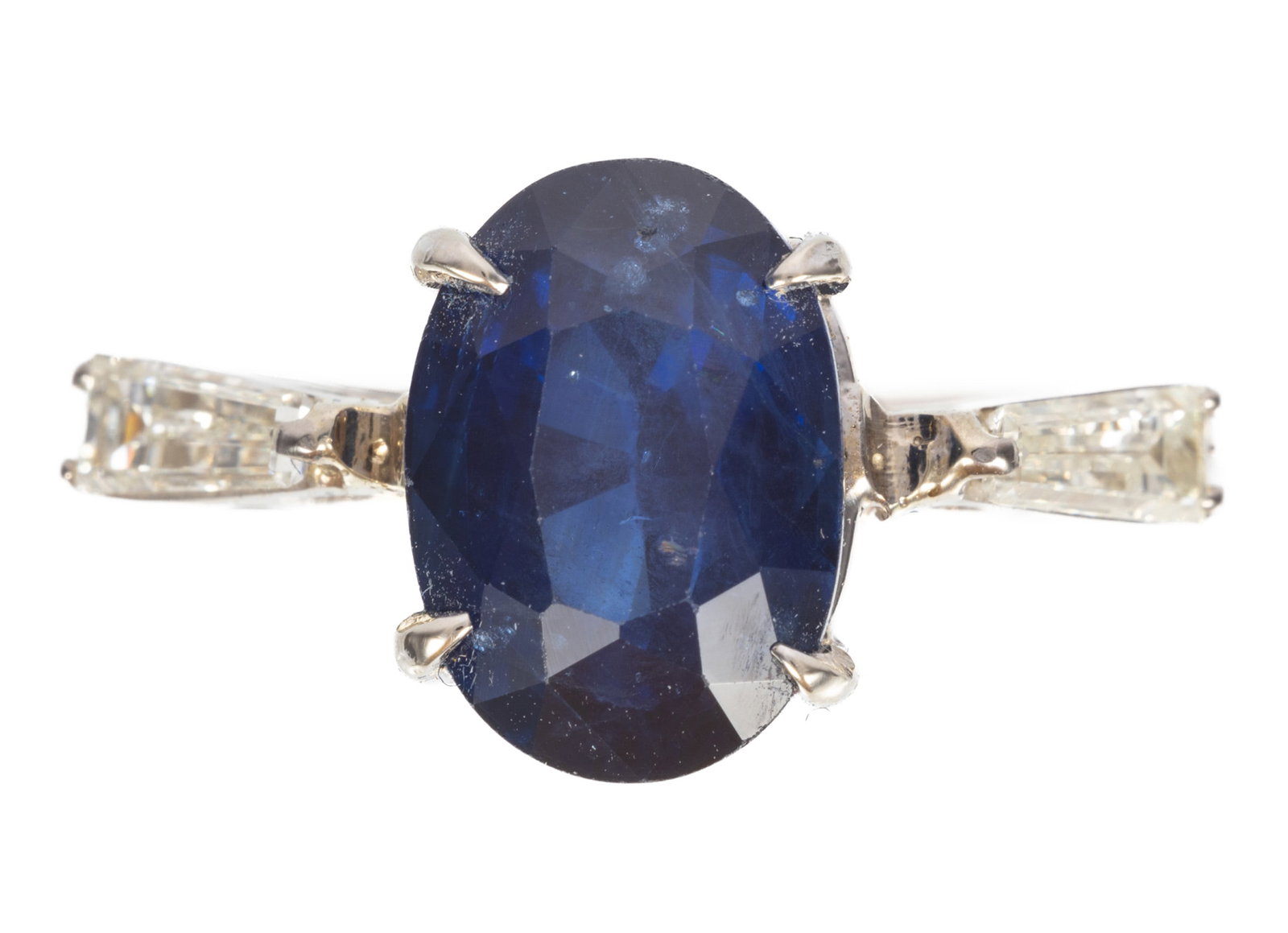 Platinum, Sapphire and Diamond Ring: Platinum, Sapphire and Diamond Ring center prong set oval brilliant faceted cut sapphire, wt. approx. 5.64 cts.; flanked by 2 baguette cut diamonds, total wt. approx. 0.20 ct.; size 8; GGA and GIA rep